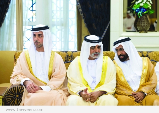 ABU DHABI, UNITED ARAB EMIRATES - July 17, 2015: HH Sheikh Omar bin Zayed Al Nahyan Deputy Chairman of the Board of Trustees of Zayed bin Sultan Al Nahyan Charitable and Humanitarian Foundation (L), and HH Sheikh Nahyan bin Mubarak Al Nahyan Minister of Culture Youth and Community Development (C), attend an Eid Al Fitr reception at Mushrif Palace. ( Ryan Carter / Crown Prince Court - Abu Dhabi ) ---